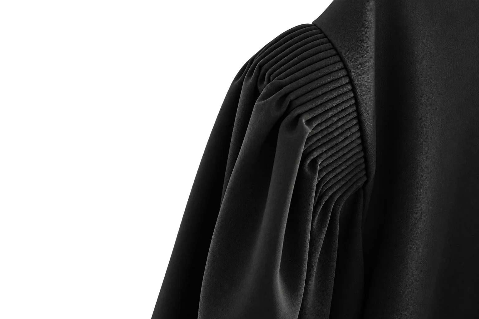 Gros plan sur l’épaule plissée d’une robe d’avocat noire.